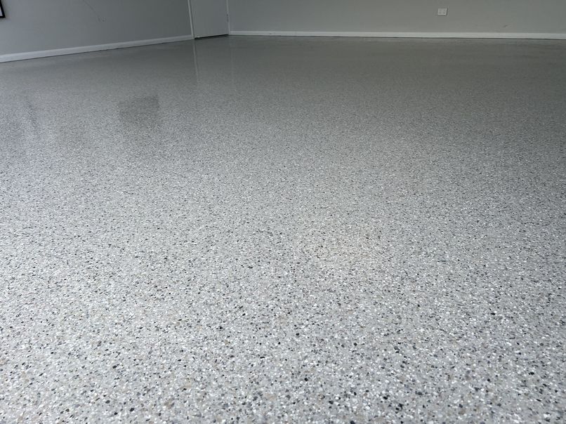 Light grey flake epoxy flooring with a low-gloss sealed finish