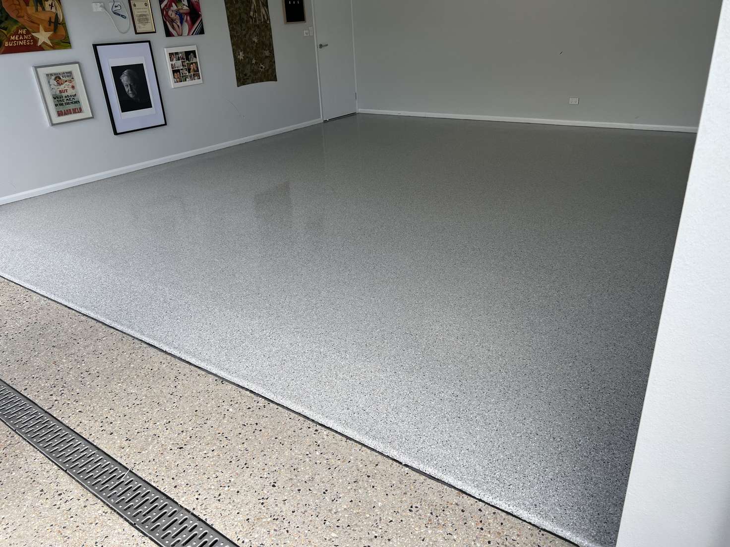 Light grey flake epoxy floor with a matching coated driveway apron and drain