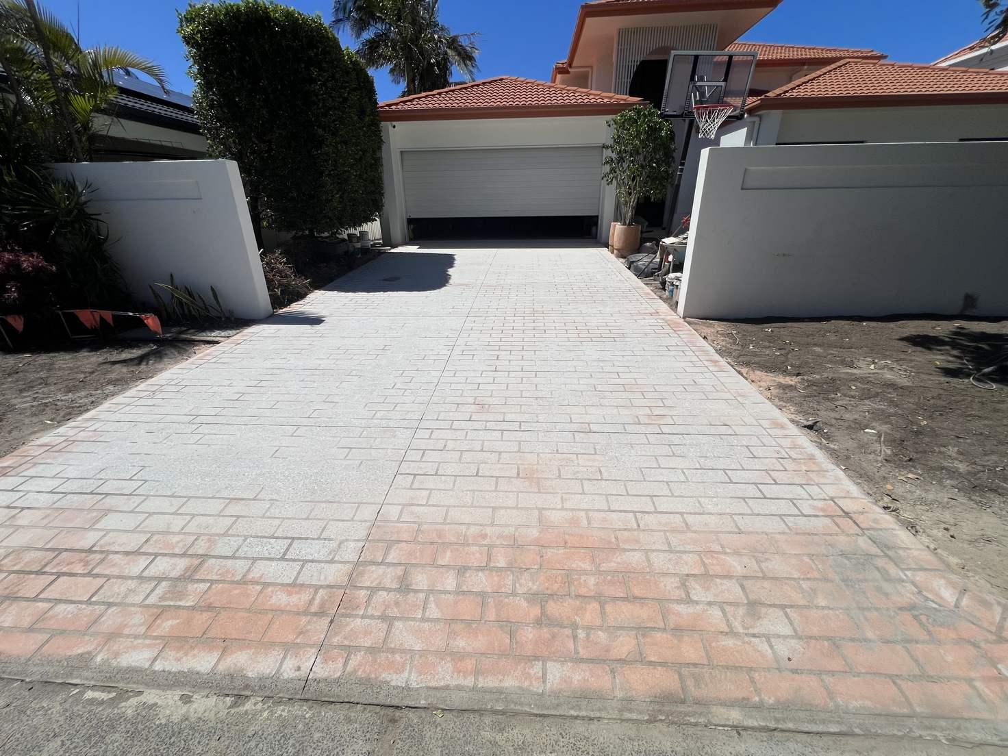 A faded stamped-concrete driveway before epoxy resurfacing, Sunshine Coast