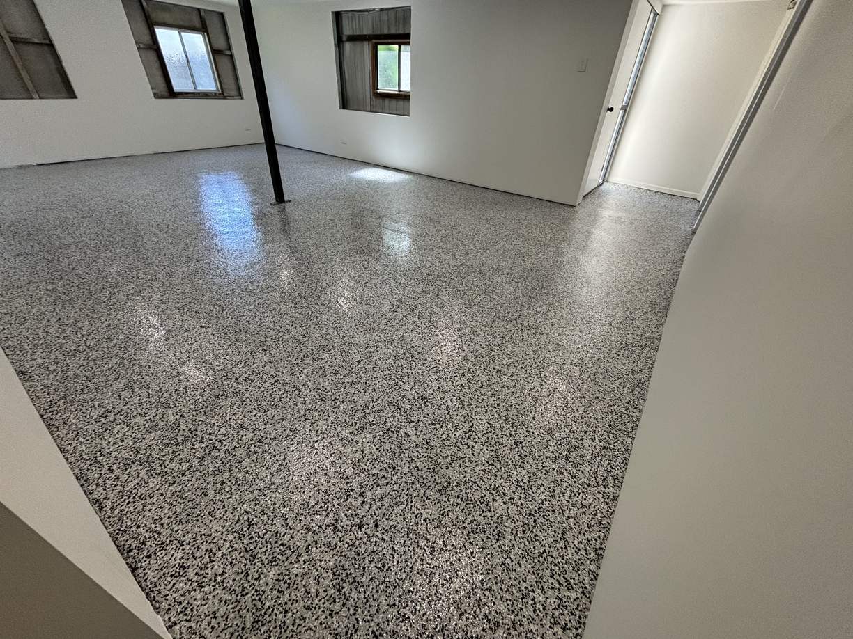 Grey speckle flake epoxy floor through a converted under-house garage room
