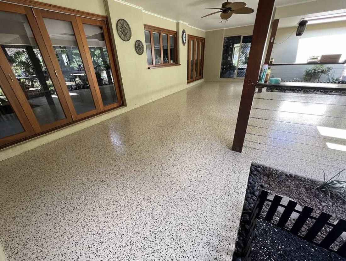 An outdoor entertaining area finished in cream and black speckle flake epoxy